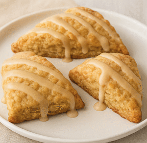 Three delicious maple scones on a white plate, made with Dodge's pure New Hampshire maple syrup.